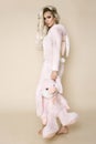 Beautiful blonde woman wearing a pajama, a bunny costume, smiling happily. Fashion model in Easter bun Royalty Free Stock Photo