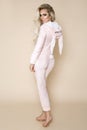 Beautiful blonde woman wearing a pajama, a bunny costume, smiling happily. Fashion model in Easter bun Royalty Free Stock Photo
