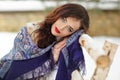 Beautiful brunette girl in a blue scarf in the winter on a Royalty Free Stock Photo