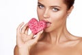 Beautiful brunette woman eating cake shape of heart romanti Royalty Free Stock Photo