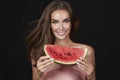 Beautiful brunette woman eating watermelon on a white background, healthy food, tasty food, organic diet, smile healthy, blac Royalty Free Stock Photo