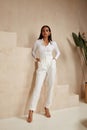 Beautiful sexy brunette woman tanned skin face cosmetic makeup wear white suit pants for date walk office fashion clothes style