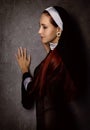 Beautiful catholic nun posing on a dark background. religious concept