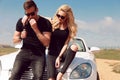 Beautiful couple in casual clothes posing beside auto Royalty Free Stock Photo