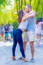 A beautiful sexy couple dancing in a city park