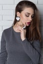 Beautiful elegant fashionable woman with bright evening make-up with big lips plump demonstrates Handmade Jewelry in fashiona Royalty Free Stock Photo