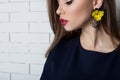 Beautiful elegant fashionable woman with bright evening make-up with big lips plump demonstrates Handmade Jewelry in fashiona Royalty Free Stock Photo