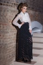 Beautiful elegant girl in evening dress in a white blouse and long black skirt, dress on new year's eve, fashion photography Royalty Free Stock Photo