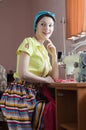 Beautiful funny young pinup woman in light green with sewing machine Royalty Free Stock Photo