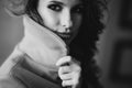 Beautiful sexy girl with curls and full lips in a coat in the style of a loft studio. Black and white art photo. Beauty and Royalty Free Stock Photo