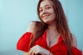 Beautiful sexy girl in a red dress with long hair laughs. Woman dancing near a fountain in the rain with wet hair Royalty Free Stock Photo