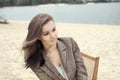 Beautiful girl sitting in chair on the beach