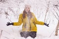 Beautiful sexy girl tosing snow. around the trees in the snow