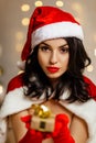 Beautiful sexy girl wearing santa claus clothes with christmas gift Royalty Free Stock Photo