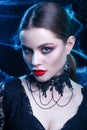 Close-up of beautiful sexy Halloween vampire woman portrait on dark magic background Royalty Free Stock Photo