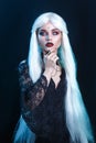 Beautiful sexy Halloween vampire woman portrait on dark magic background Royalty Free Stock Photo