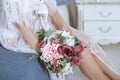 Beautiful lady in elegant white robe and bouquet Royalty Free Stock Photo