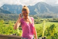 Beautiful lady standing on the top of the peak and living life. Royalty Free Stock Photo