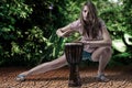 Beautiful blondy woman playing djembe drum