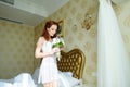 Beautiful redhair lady in elegant white panties and peignoir. Fashion portrait of model indoors. Beauty woman with lace linge Royalty Free Stock Photo