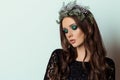Beautiful slim elegant woman with bright makeup Smoky Eyes in the New Year wreath of Christmas tree and cones