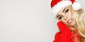 Beautiful sexy, smiling blonde female dressed in a Santa Claus hat. Beauty sensual girl for Christmas Royalty Free Stock Photo