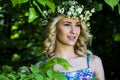 Beautiful smiling girl with a wreath on his head in the spring park Royalty Free Stock Photo