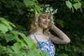 Beautiful smiling girl with a wreath on his head in the spring park Royalty Free Stock Photo