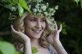 Beautiful smiling girl with a wreath on his head in the spring park Royalty Free Stock Photo