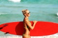 Beautiful surfer girl on the beach Royalty Free Stock Photo