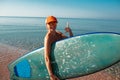 Beautiful surfer girl on the beach Royalty Free Stock Photo