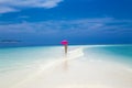 Beautiful sexy tanned woman bikini model with pink umbrella on Maldives island. Young glamour girl in swimsuit on Maldives Royalty Free Stock Photo