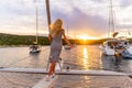 Beautiful sexy woman in dress relaxing on a yacht front at sunset Royalty Free Stock Photo