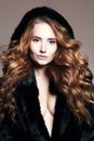 Beautiful woman in fur hood, healthy hair Royalty Free Stock Photo