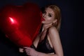 Beautiful sexy woman with heart shape air balloon on studio isolated background. Sensual woman on Valentines Day. Heart Royalty Free Stock Photo