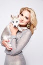 Beautiful woman hug pets dog makeup dress blond Royalty Free Stock Photo