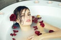 Beautiful woman takes bath rose candles Valentine's day spa Royalty Free Stock Photo