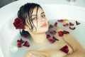 Beautiful woman takes bath rose candles Valentine's day spa Royalty Free Stock Photo