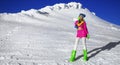 Beautiful sexy woman is wearing white fur, winter hat, scarf and winter boots. Attractive young girl in mountains Royalty Free Stock Photo