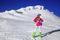 Beautiful sexy woman is wearing white fur, winter hat, scarf and winter boots. Attractive young girl in mountains Royalty Free Stock Photo