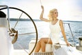 Beautiful young blonde woman, riding a boat on the water, itinerary, beautiful makeup, clothing, summer, sun, perfect body fi Royalty Free Stock Photo