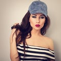 Beautiful young make-up model in fashion blue cap posing an Royalty Free Stock Photo