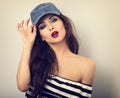 Beautiful young make-up model holding blue cap with long ha Royalty Free Stock Photo