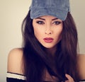 Beautiful young make-up model posing in blue baseball cap w Royalty Free Stock Photo