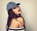 Beautiful young make-up model posing in blue cap with long Royalty Free Stock Photo