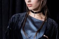 Beautiful young woman with dark hair braided with bright makeup and fashion jewelry choker around her neck, fashion jewelry s Royalty Free Stock Photo