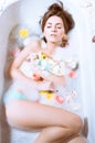 Beautiful young woman having bath with flower petals Royalty Free Stock Photo
