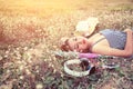 Beautiful young woman lying nearing headphone in the flower Royalty Free Stock Photo