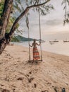 Beautiful, sexy, young woman posing on the beach in Thailand, Phangan island wearing red bikiniWoman standing on a swing on the be Royalty Free Stock Photo