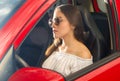 Beautiful young woman posing for camera and wearing a white blouse while the sun is reflecting over her face and Royalty Free Stock Photo